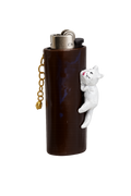 A dark brown lighter case shaped accessory with a small white cat figure climbing the side and a chain hanging from the top.
