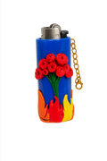 A blue lighter case decorated with red roses and orange, yellow, and red flames.

Flowers and Flames colourful floral polymer clay lighter case with keychain
