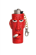 A red lighter case shaped like a stylized face with a cigarette in its mouth, featuring a silver metal top and a gold-and-silver keychain attached.