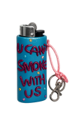 A turquoise blue novelty lighter with the text 'I CAN'T SMOKE WITH US' in dark pink bubble letters, decorated with small rhinestones, featuring a pink cord and silver metal keychain clasp on a white background.
U Can’t Smoke With Us handmade colourful lighter case with keychain